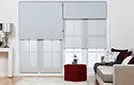 light charcoal grey roller blinds creating a bold contrast against a light-colored wall.